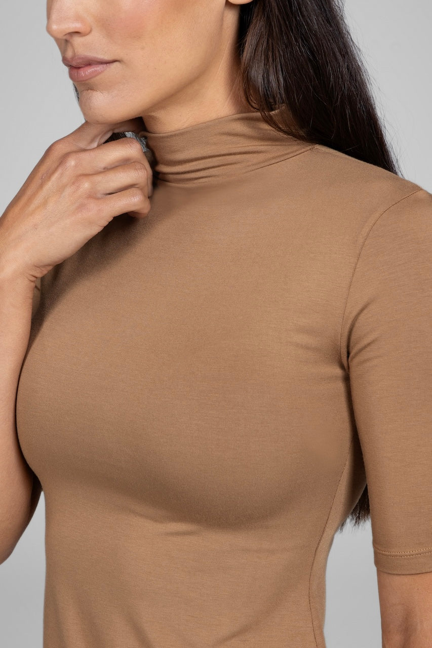 Detailed view of a camel mock neck tee featuring a luxurious, soft texture and medium compression.