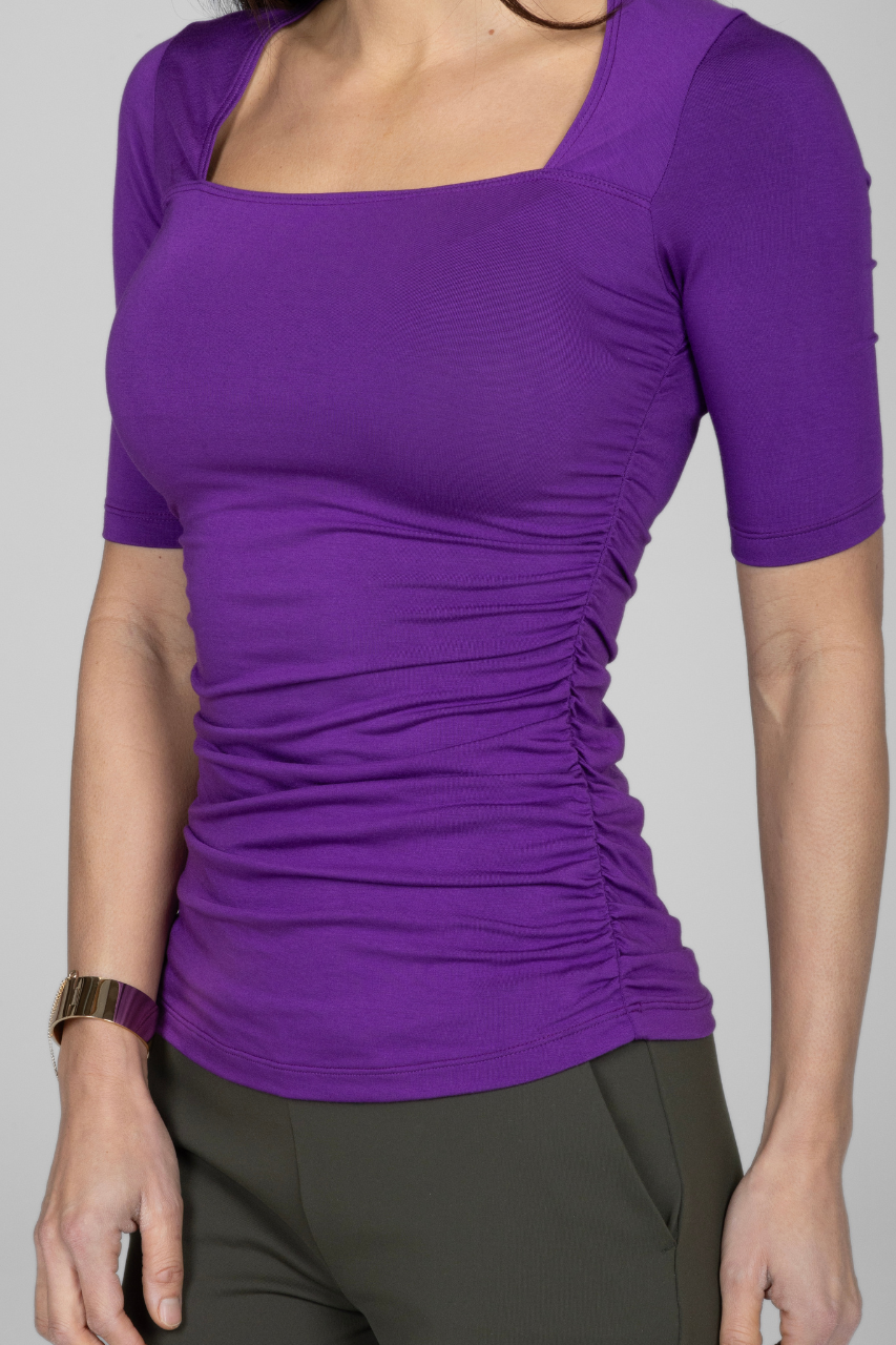Close up photo of purple short sleeve top with square neck and ruching