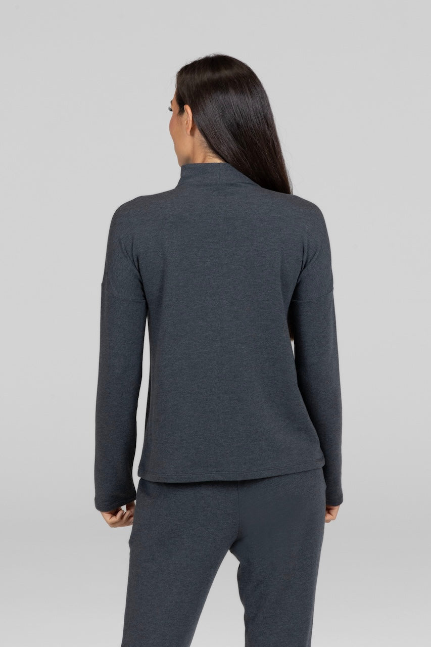 Back view of charcoal grey long sleeve mock neck top and matching sweatpants