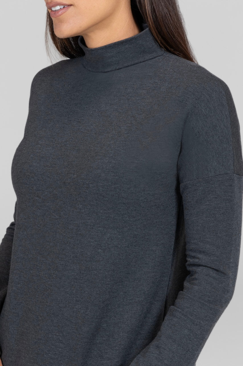 Close up of woman wearing charcoal grey mock neck long sleeve pullover