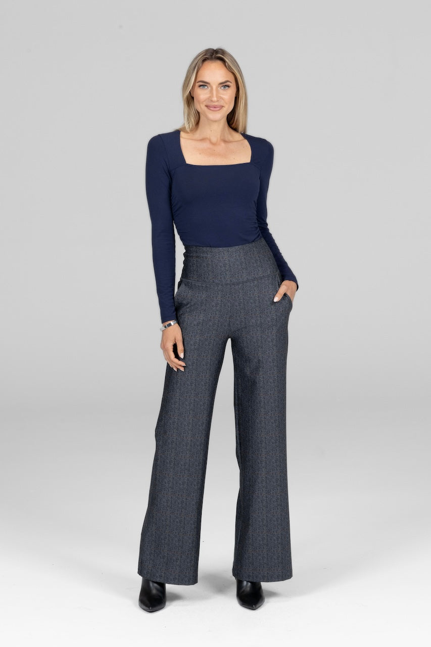 Model wearing Irish Tartan High Waist Wide Leg Pant paired with a fitted blouse for a stylish, contemporary look.