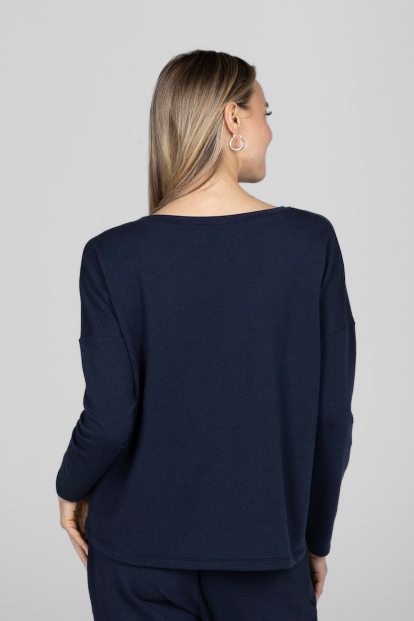 Back view of woman wearing navy long sleeve top