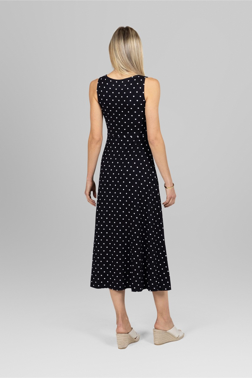 Back view of woman wearing black dotted maxi dress