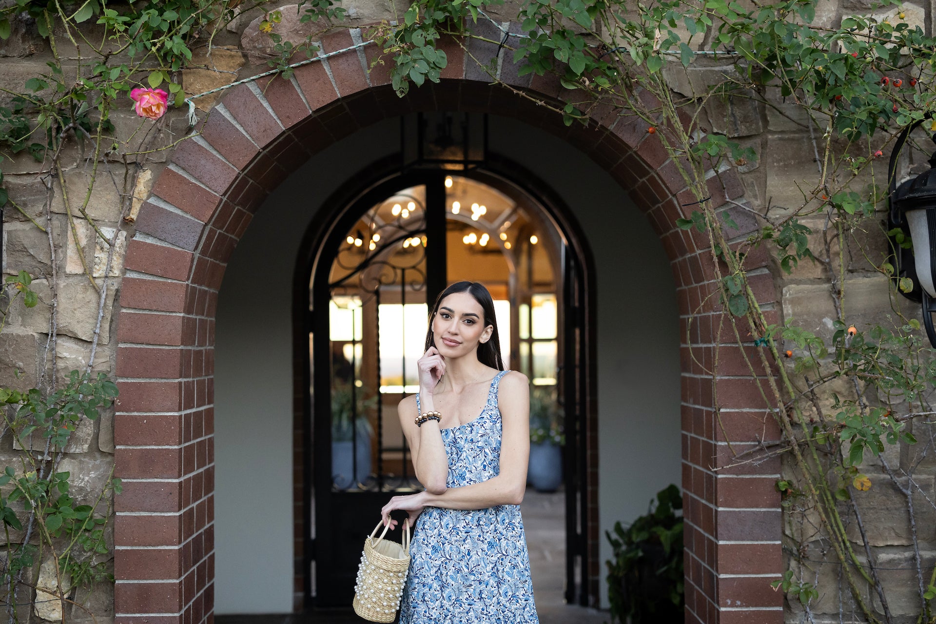 Model in front of a garden building in JULIETTE MIDI DRESS: COTTAGE GARDEN 