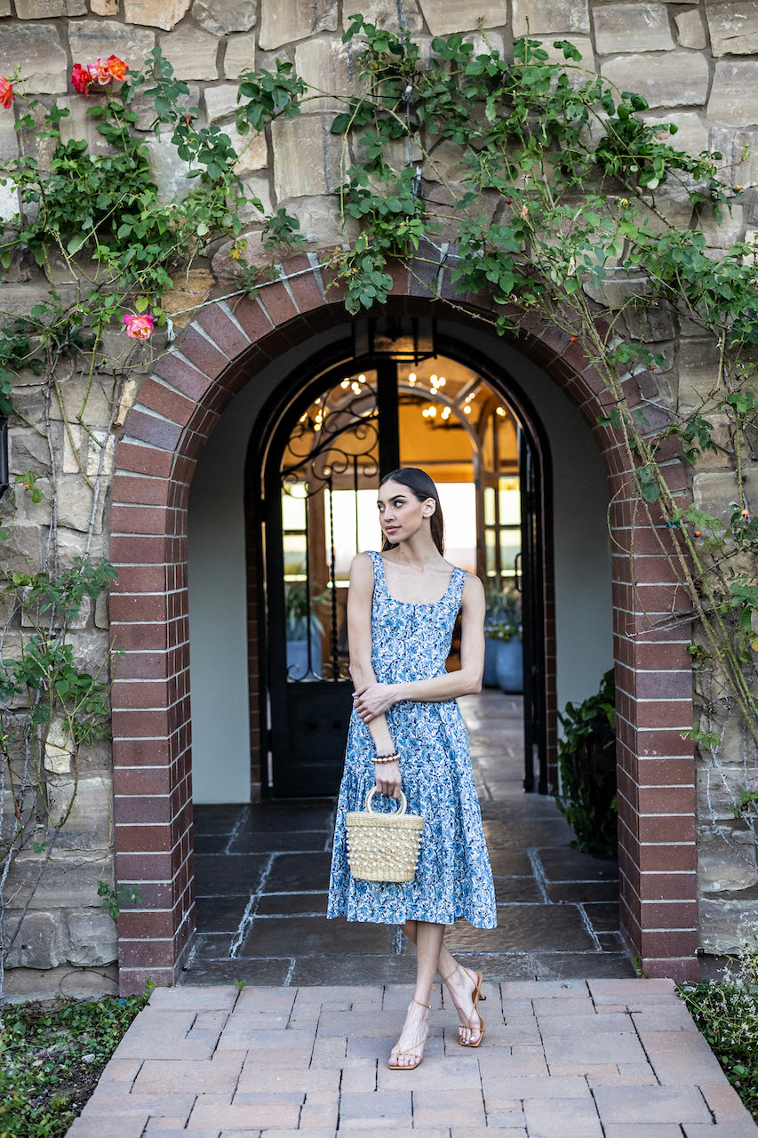 Model in front of a garden buidling in JULIETTE MIDI DRESS: COTTAGE GARDEN