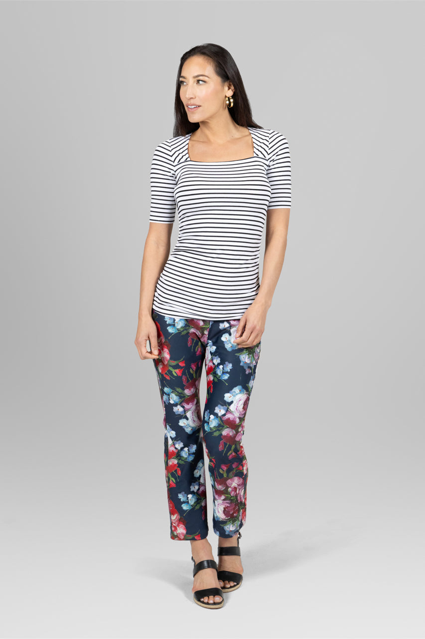 Model wearing a striped top paired with the High Waist Ankle Kick Pant in spring floral, showcasing a playful and stylish contrast perfect for a casual day out