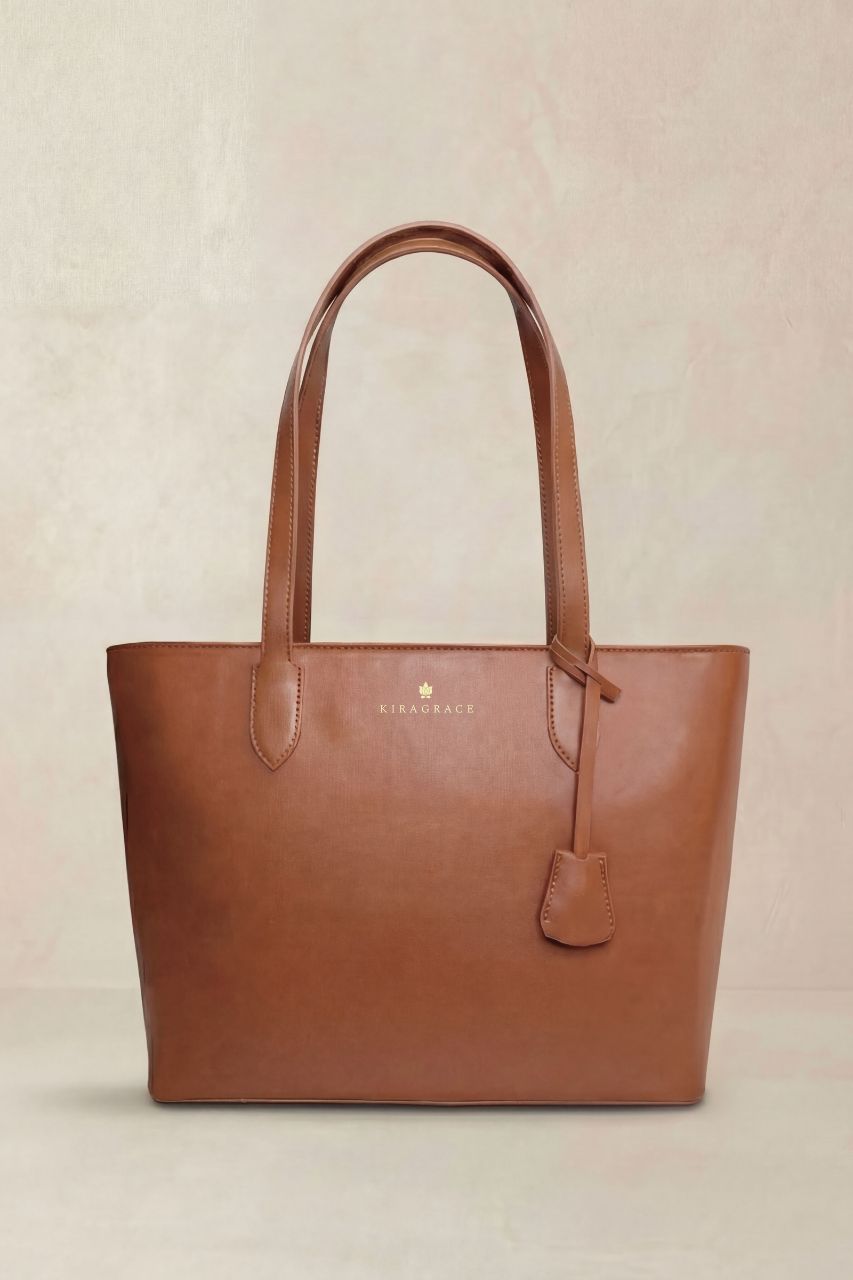 Brown PU leather tote bag with a KiraGrace brand logo on a beige background