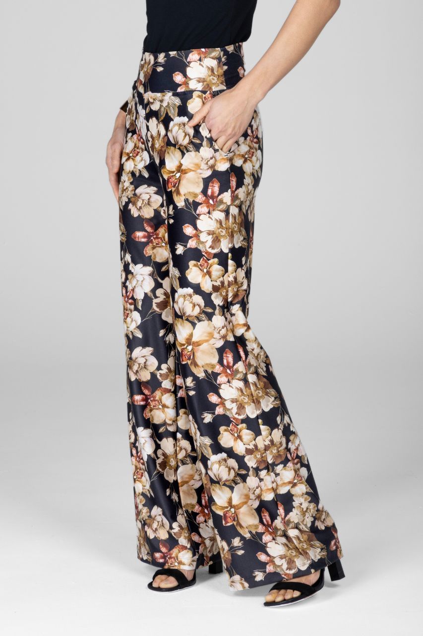 Floral patterned high waist wide leg pants worn by a woman showing the side