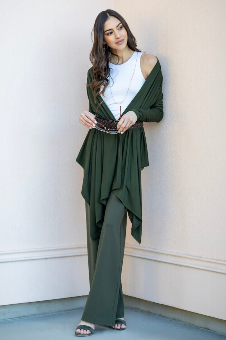 Woman wearing green cardigan and matching wide leg pants with white tank top underneath