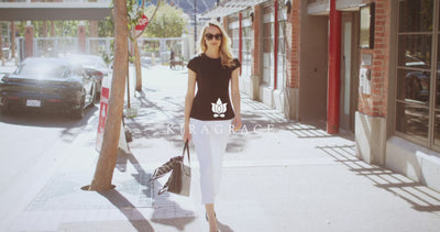 Woman walking on the sidewalk and downtown showing fast paced moving and new black and white collection