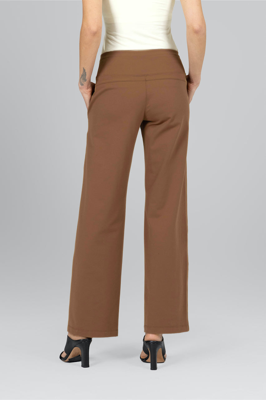 Back view of woman wearing dark khaki traveler pants